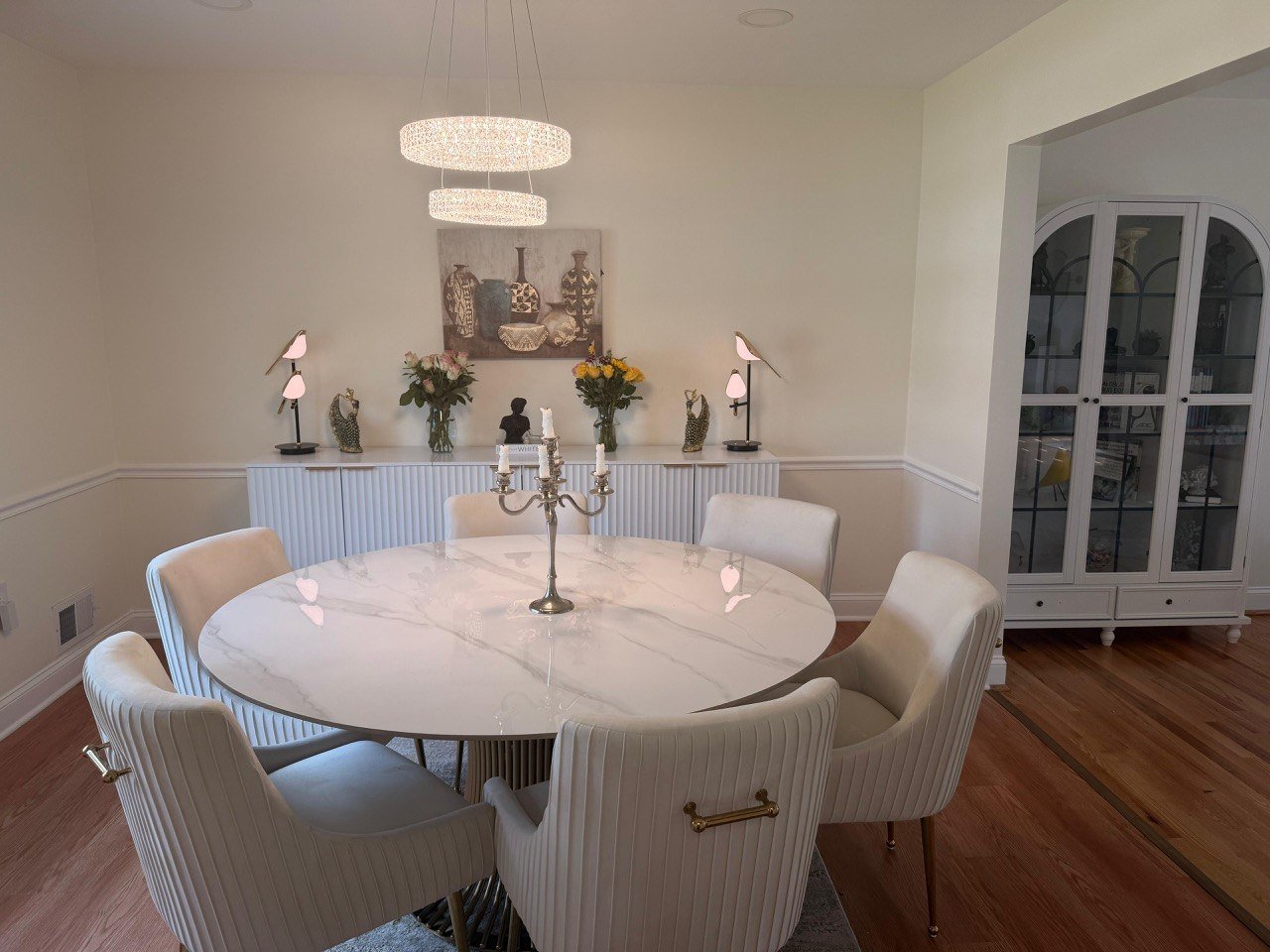 Elegant modern dining room with marble table and chandelier